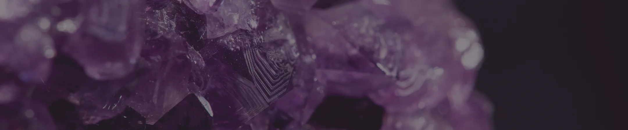 Close-up of deep purple amethyst crystals used as a banner image for Saluxe blog posts and other pages.