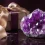 Amethyst crystal cluster next to an elegant gift box with a satin ribbon.