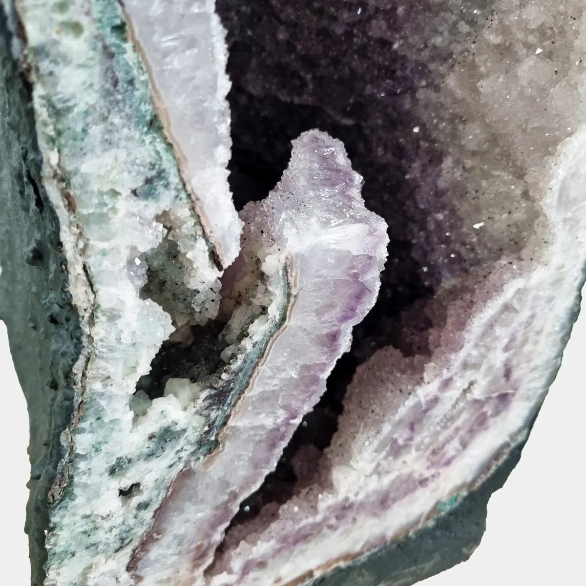 Close-up of the distinctive projecting crystal cluster at the lower edge, revealing natural geometry and radiant transparency.