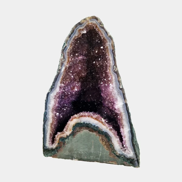 Front view of the 31 cm Amethyst Cathedral revealing deep violet crystal layers framed by white quartz and polished basalt edges.