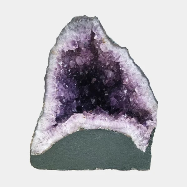 Front view of the 28 cm Amethyst Cathedral revealing vibrant violet crystals framed by light quartz and smooth basalt base.