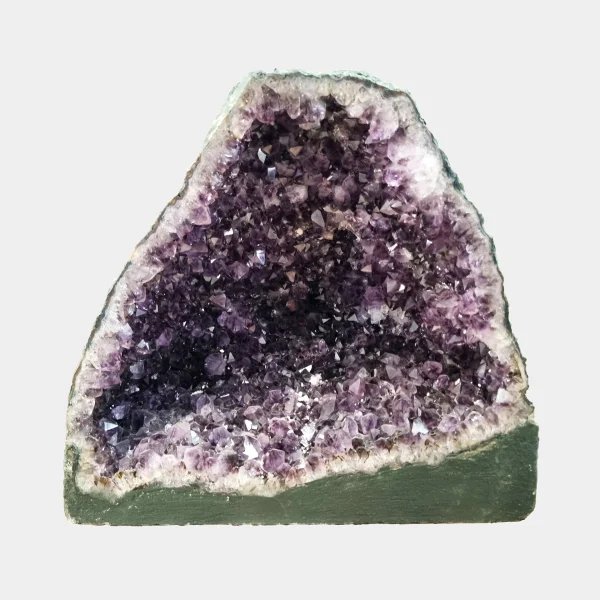 Front view of the 32 cm Amethyst Cathedral revealing deep violet crystal layers framed by pale quartz and natural basalt base.