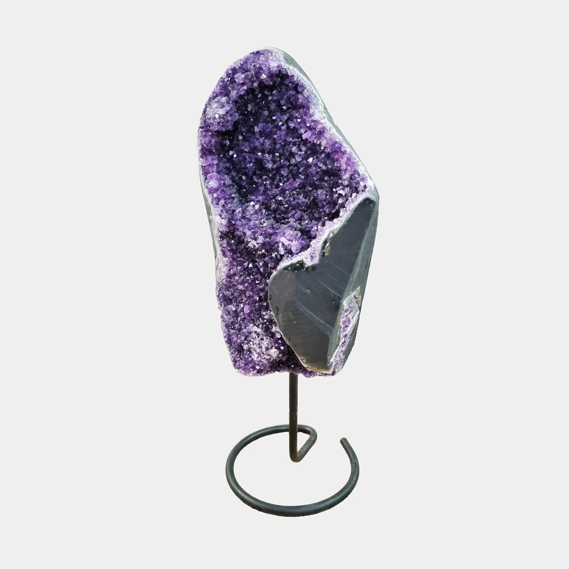 Amethyst on Stand N°2 – 43 cm – Side View 1 Side view of Luxury Amethyst geode on metal stand showing crystal depth and natural contours.