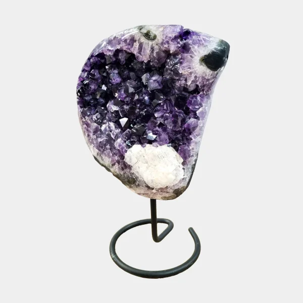 Alternate side view highlighting the depth and symmetry of the geode cavity and its lustrous violet crystals.