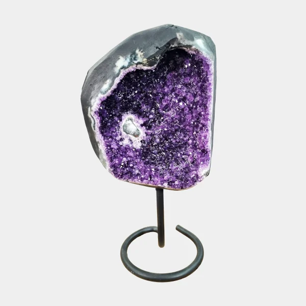 Front view of Brazilian Amethyst on elegant black metal stand – 38 cm collector piece with central natural inclusion and radiant violet crystals.