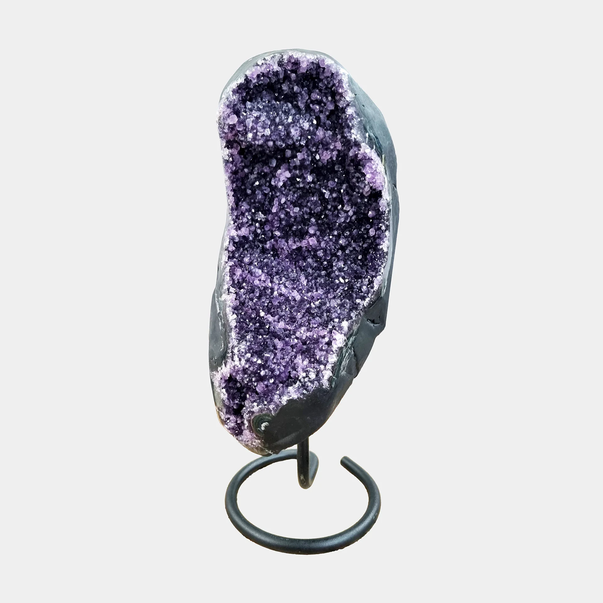 Amethyst on Stand N°7 – 39 cm – Front View Front view of Brazilian Amethyst on elegant black metal stand, tall curved geode with deep violet crystal interior.