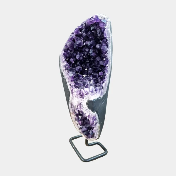 Front view of tall Brazilian Amethyst on square metal stand, slender geode with refined violet crystal interior.