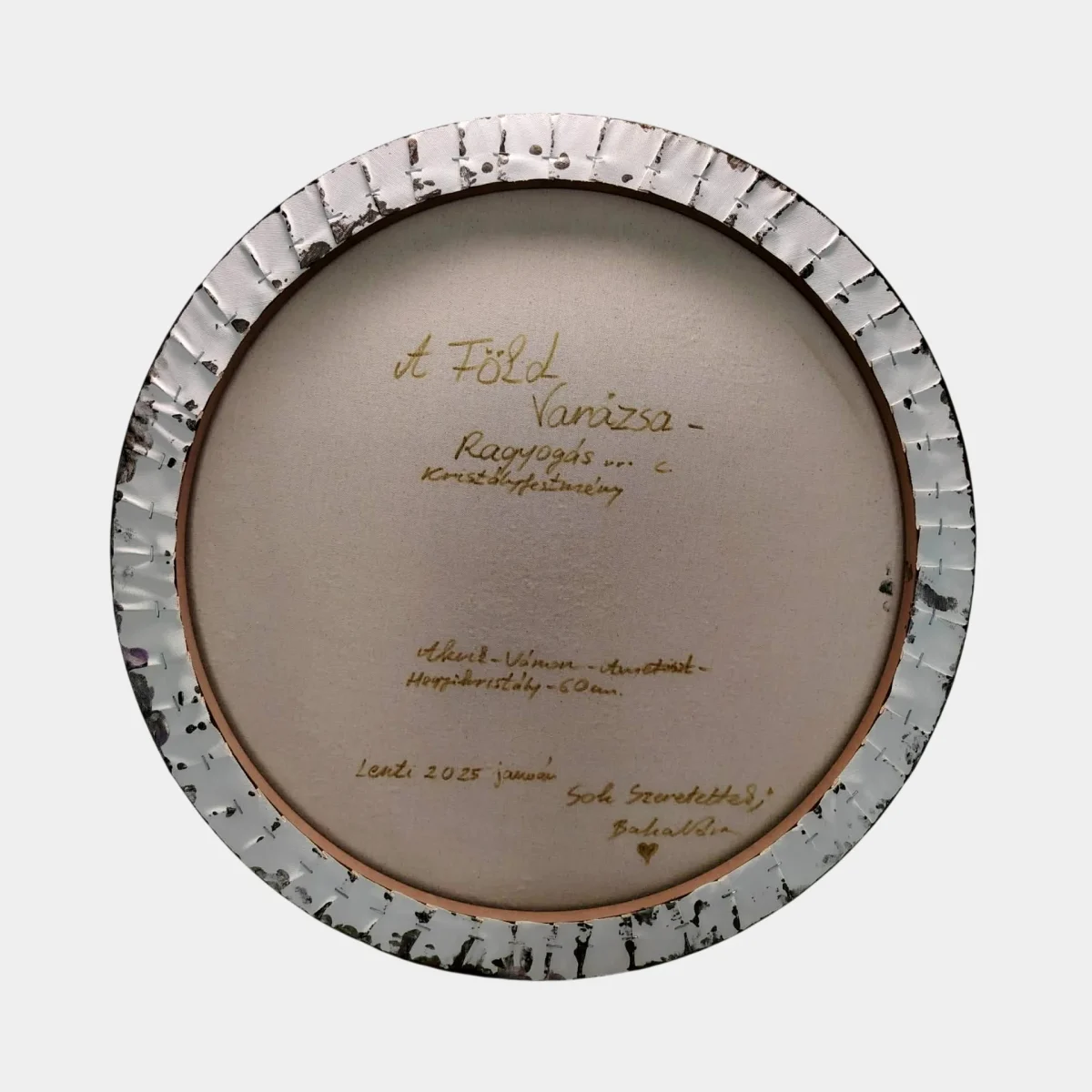 Back of the circular canvas with handwritten signature and artwork details