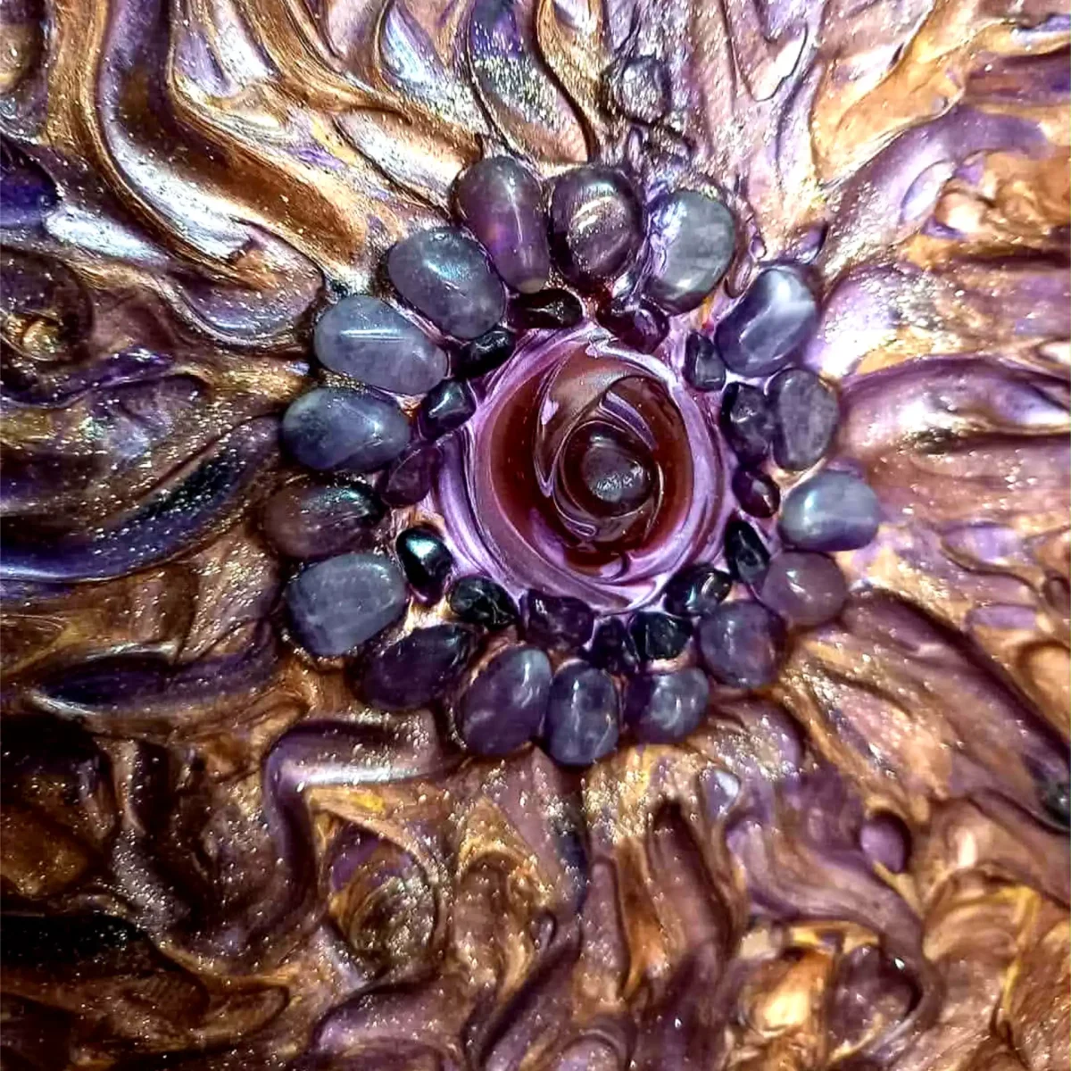 Close-up of the central motif with polished stones and layered metallic paint