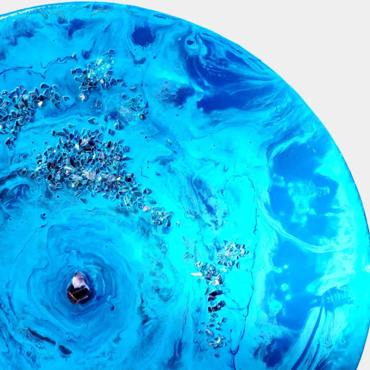 Close-up of the painting with blue swirls, crystal fragments, and a central stone