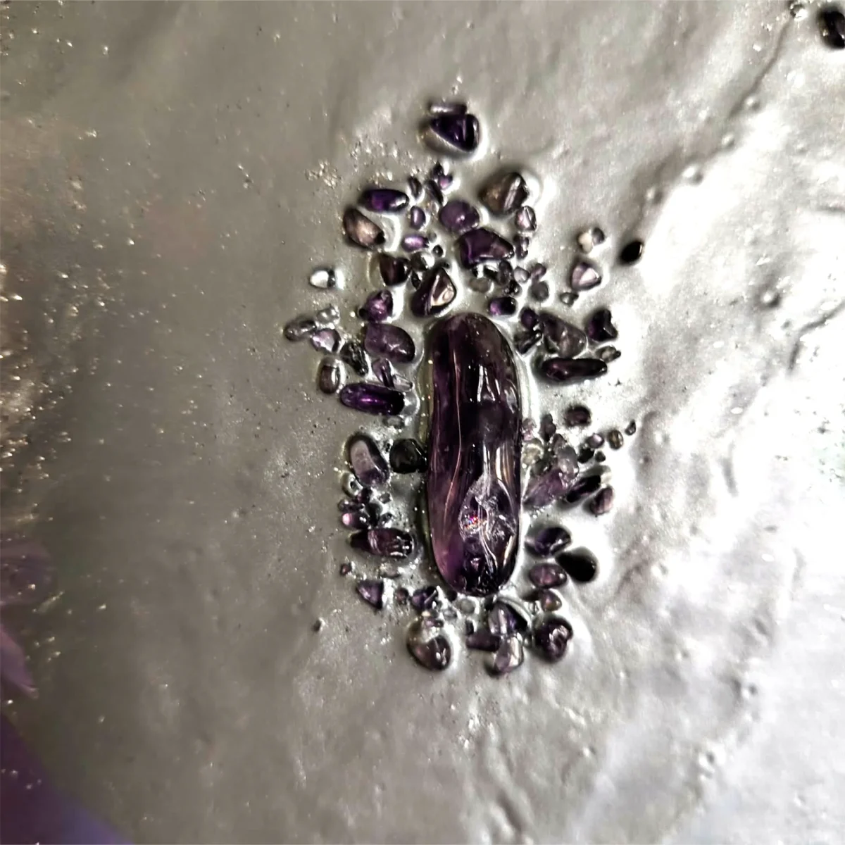 Central crystal arrangement with raw and polished amethyst on pale lilac paint