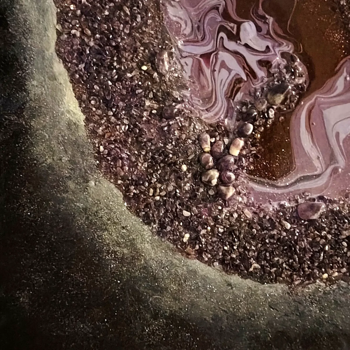 Textured border of dark amethyst crystals surrounding a marbled purple interior resembling a geode