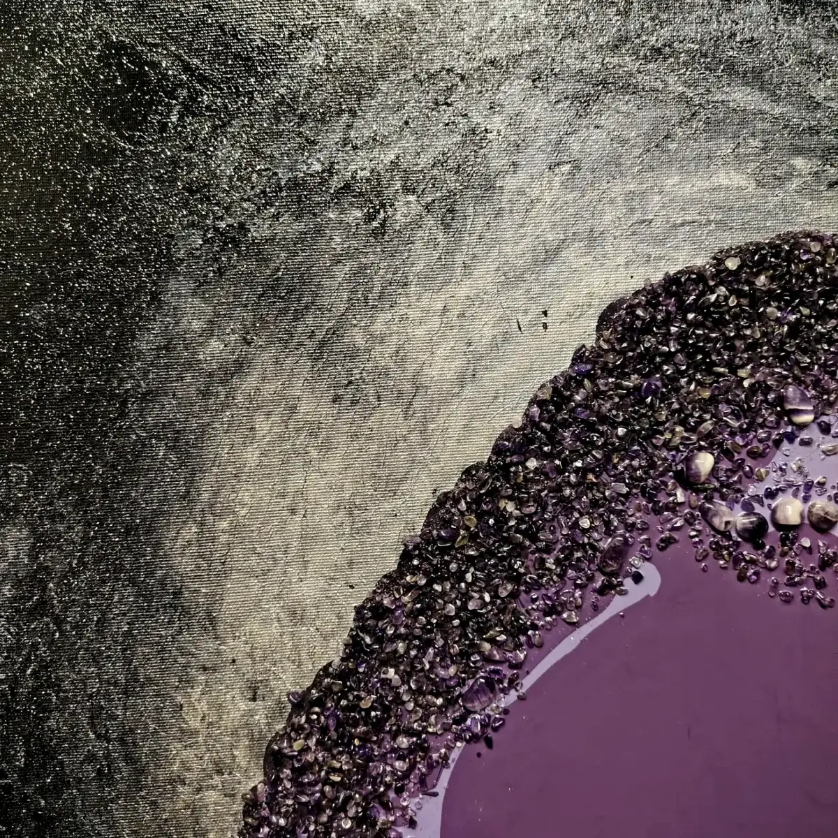 Edge of the crystal composition meeting a metallic silver textured background