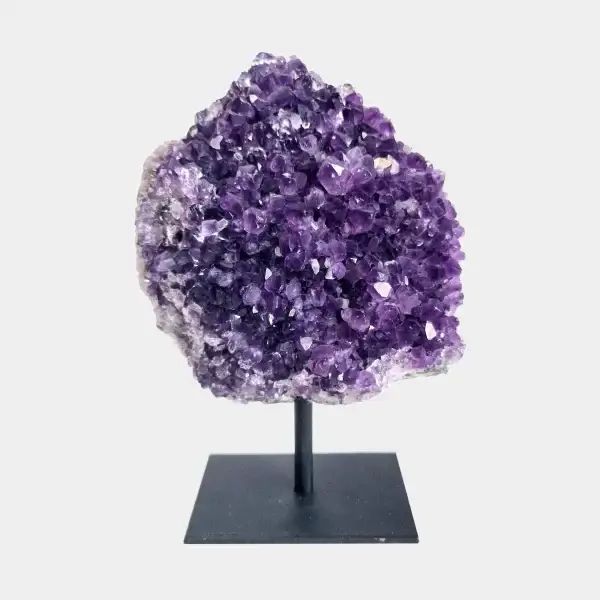 Front view of an amethyst cluster on a black metal stand with deep violet crystal points.