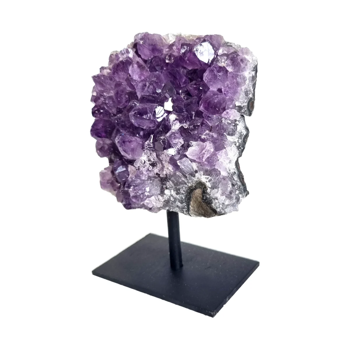 Angled front view of an amethyst cluster on stand with violet crystals and a black metal base.