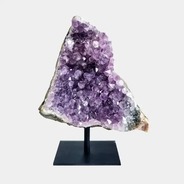Front view of an amethyst cluster on a black metal stand with violet crystals and a triangular natural shape.