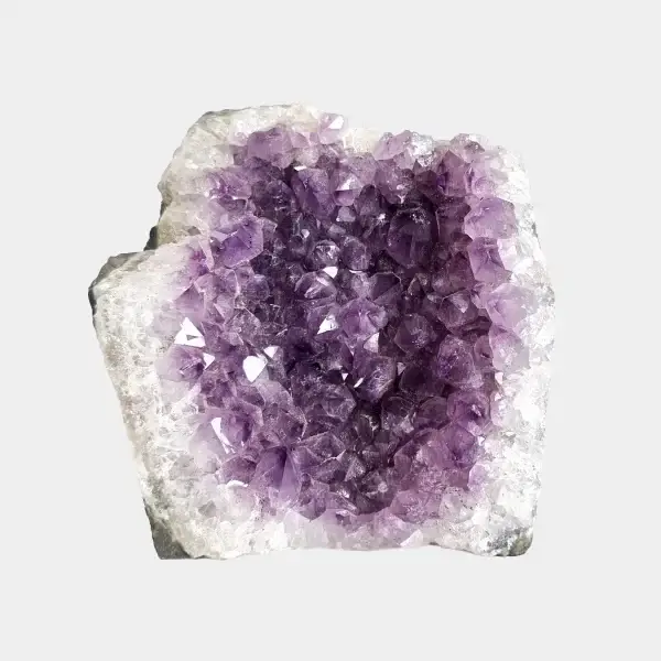 Front view of a small amethyst geode with deep violet crystals and a pale quartz outer edge.