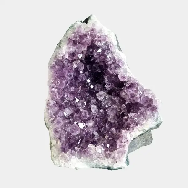 Front view of a small amethyst geode with violet crystals, pale quartz edges, and a natural stone base.
