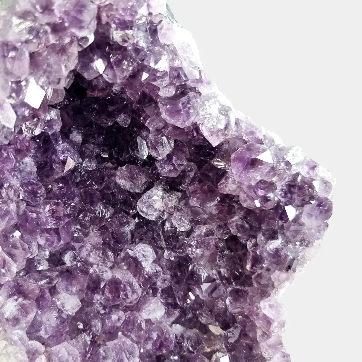 Close-up of violet amethyst crystals inside a small geode.