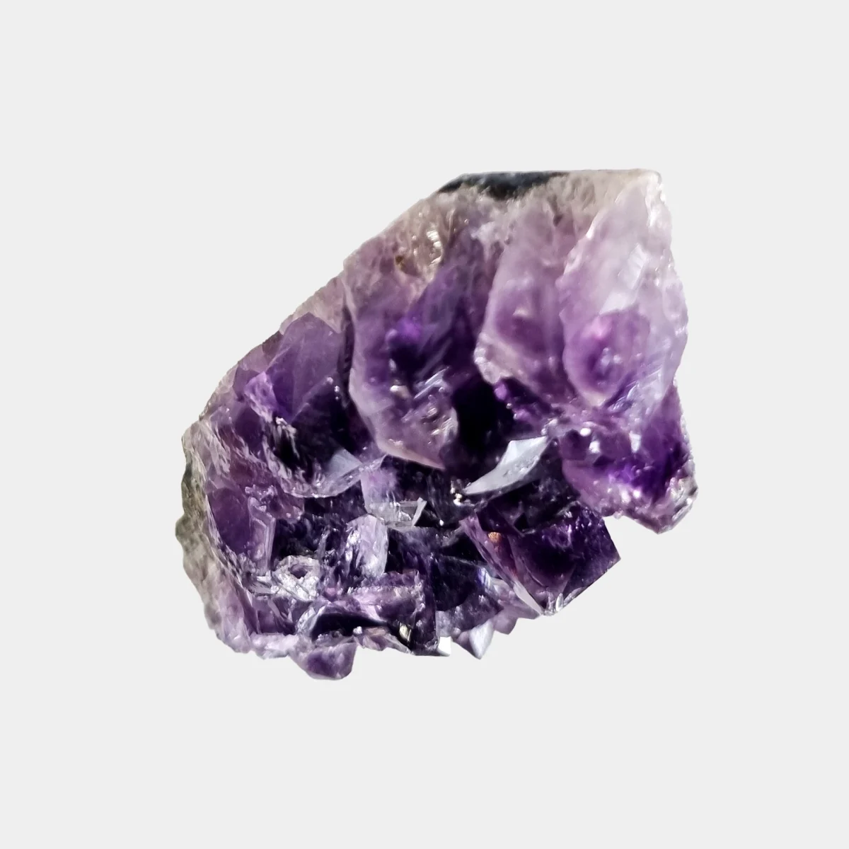 Top view of a small amethyst geode showing large purple crystal points.