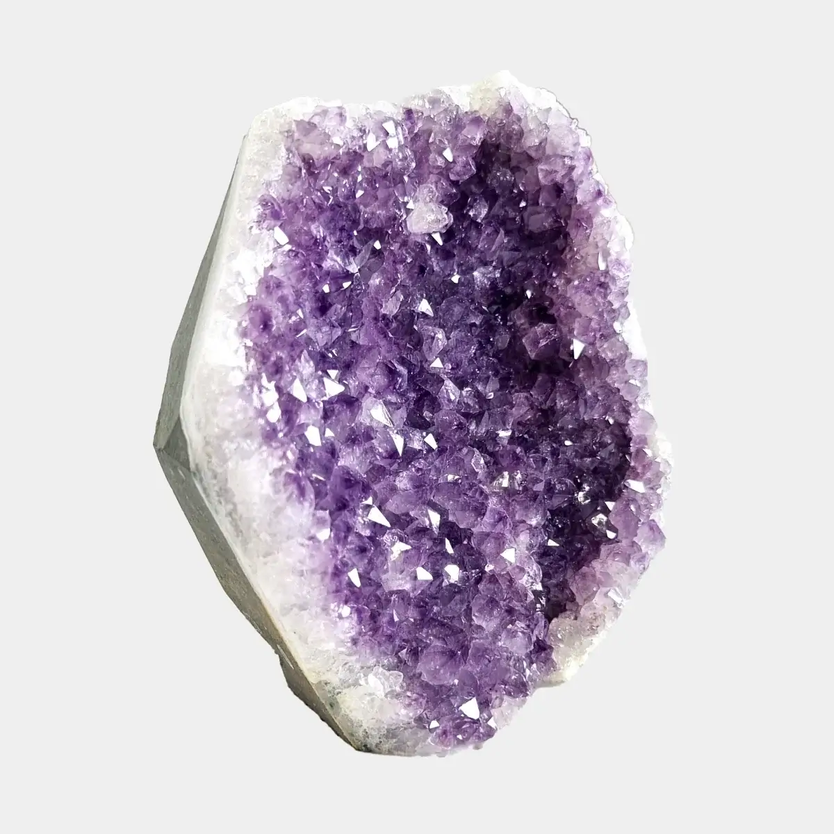 Angled front view of a small amethyst geode with purple crystals and a pale quartz border.